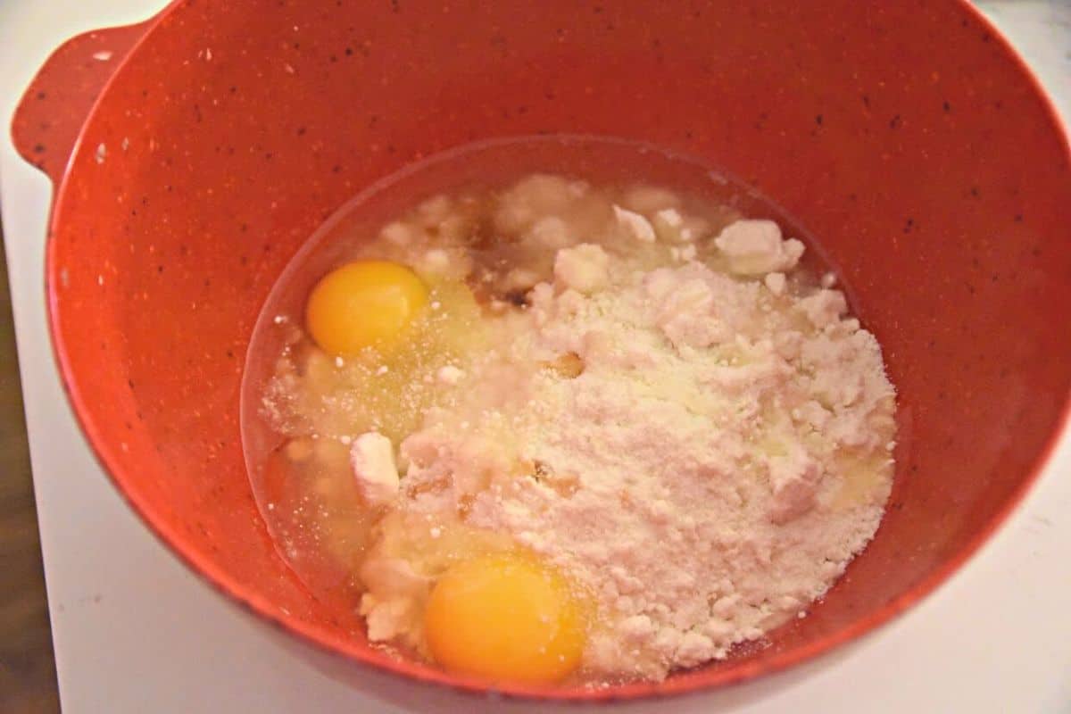 cake mix oil and eggs in red bowl.