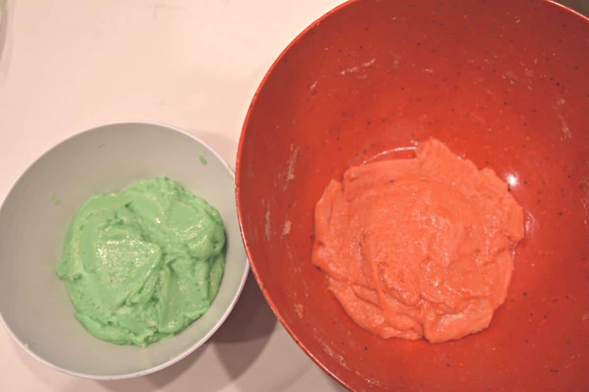 red and green cookie dough in bowls.