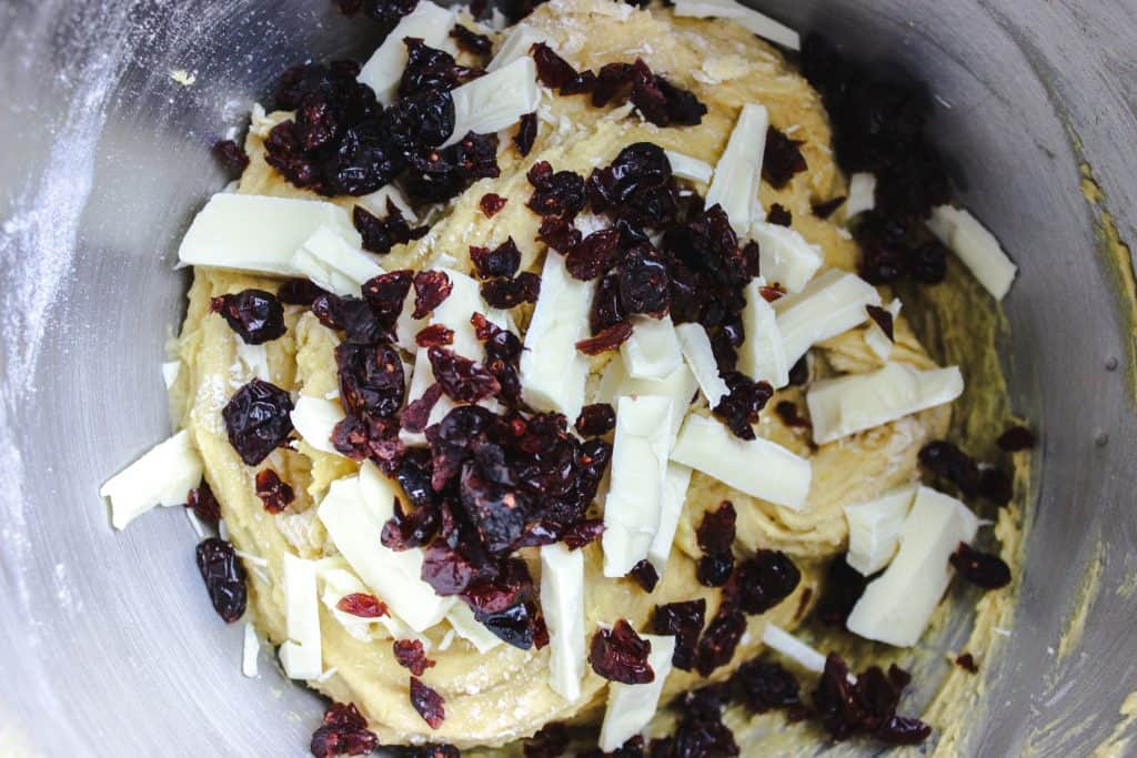craisins, white chocolate and batter in a bowl
