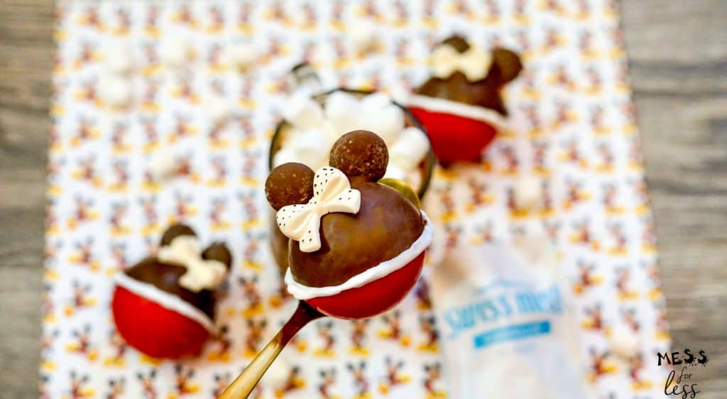 minnie mouse hot cocoa bomb on a gold spoon