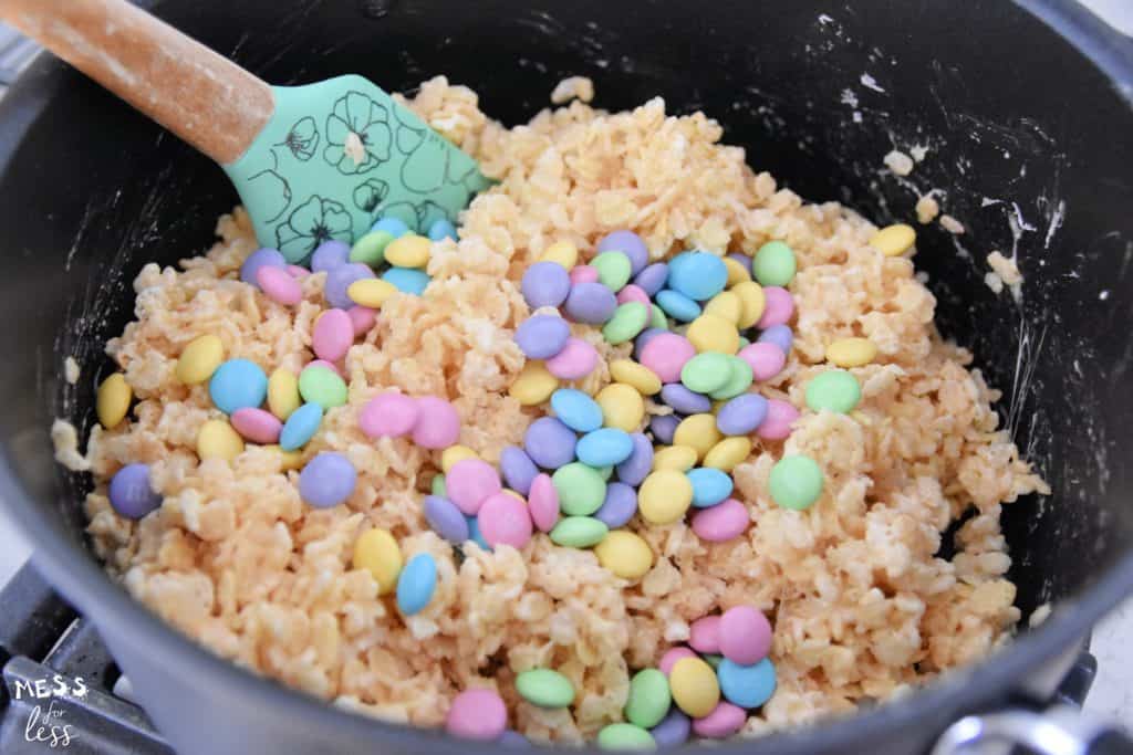 M&Ms and rice krispies in a sauce pan