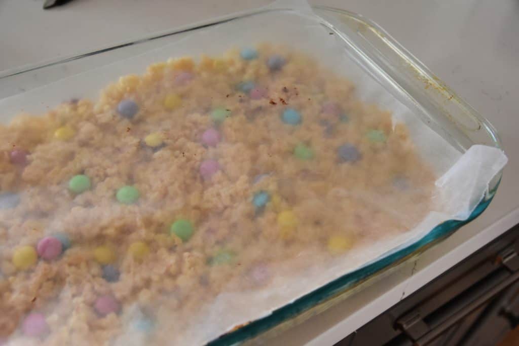 rice krispie treats in a pan with wax paper on top