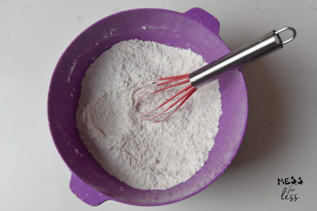 flour and whisk in a purple bowl