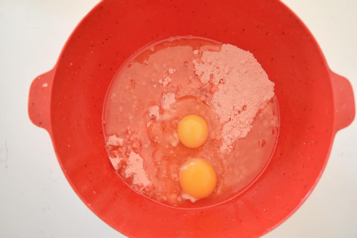 red bowl with cake mix, oil and eggs