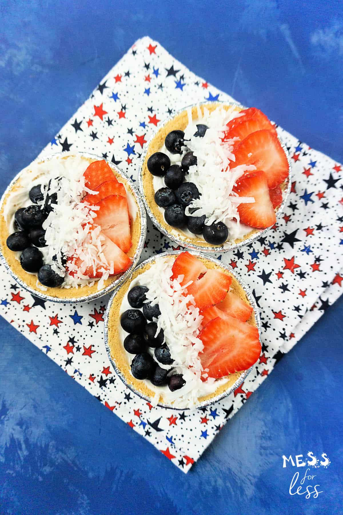 blueberry and strawberry mini cream pies on a star background