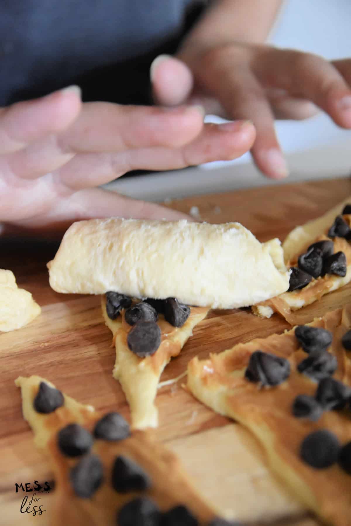rolling up a  chocolate peanut butter crescent roll