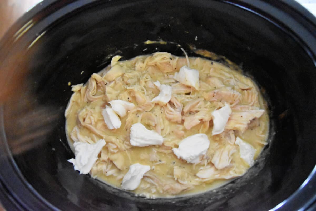 chicken in a slow cooker with soup and cream cheese