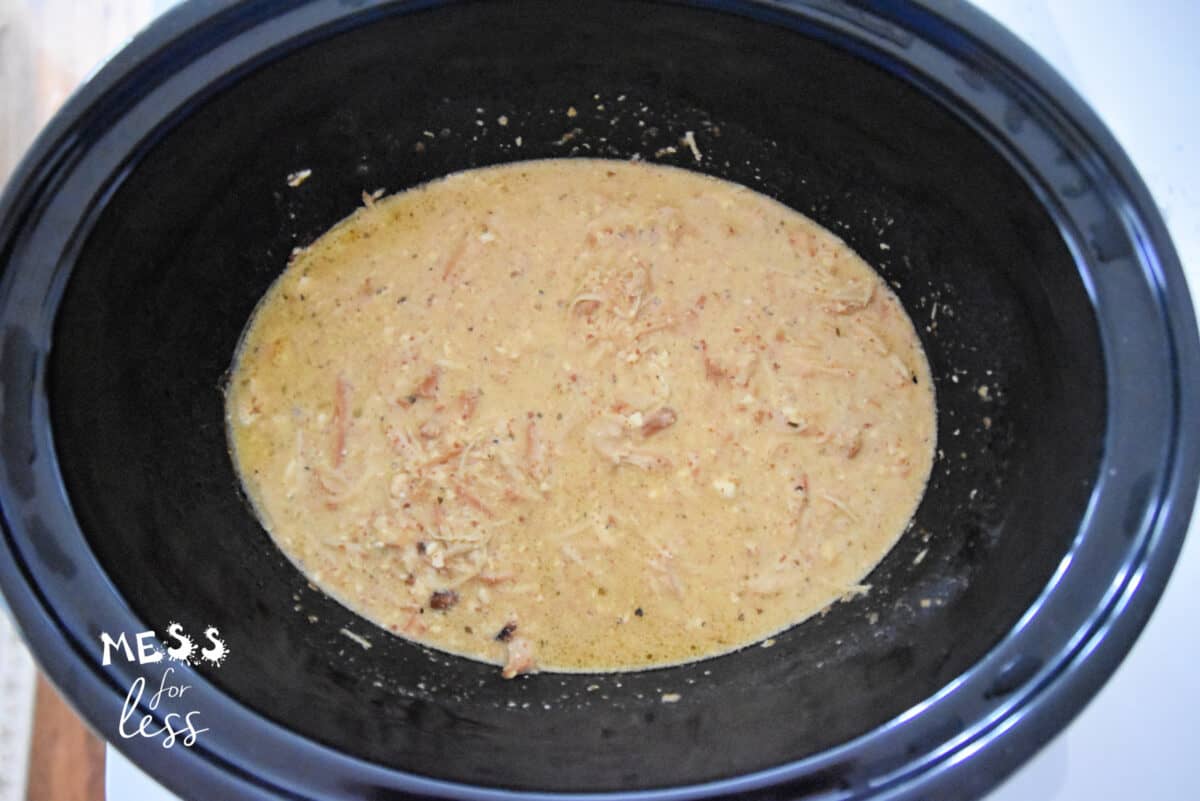 shredded chicken in a crockpot with sauce