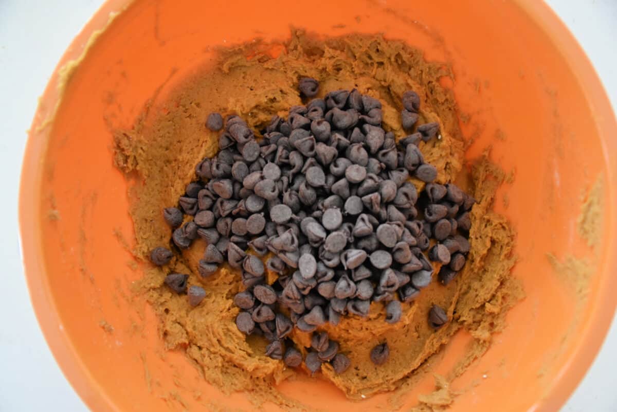 pumpkin cookie dough and chocolate chips in an orange bowl