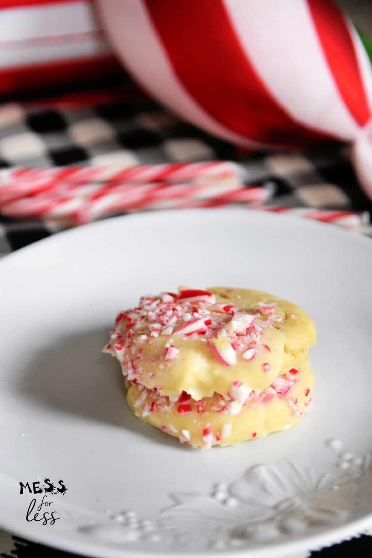 stacked sugar cookies with crushed candy canes on a plate