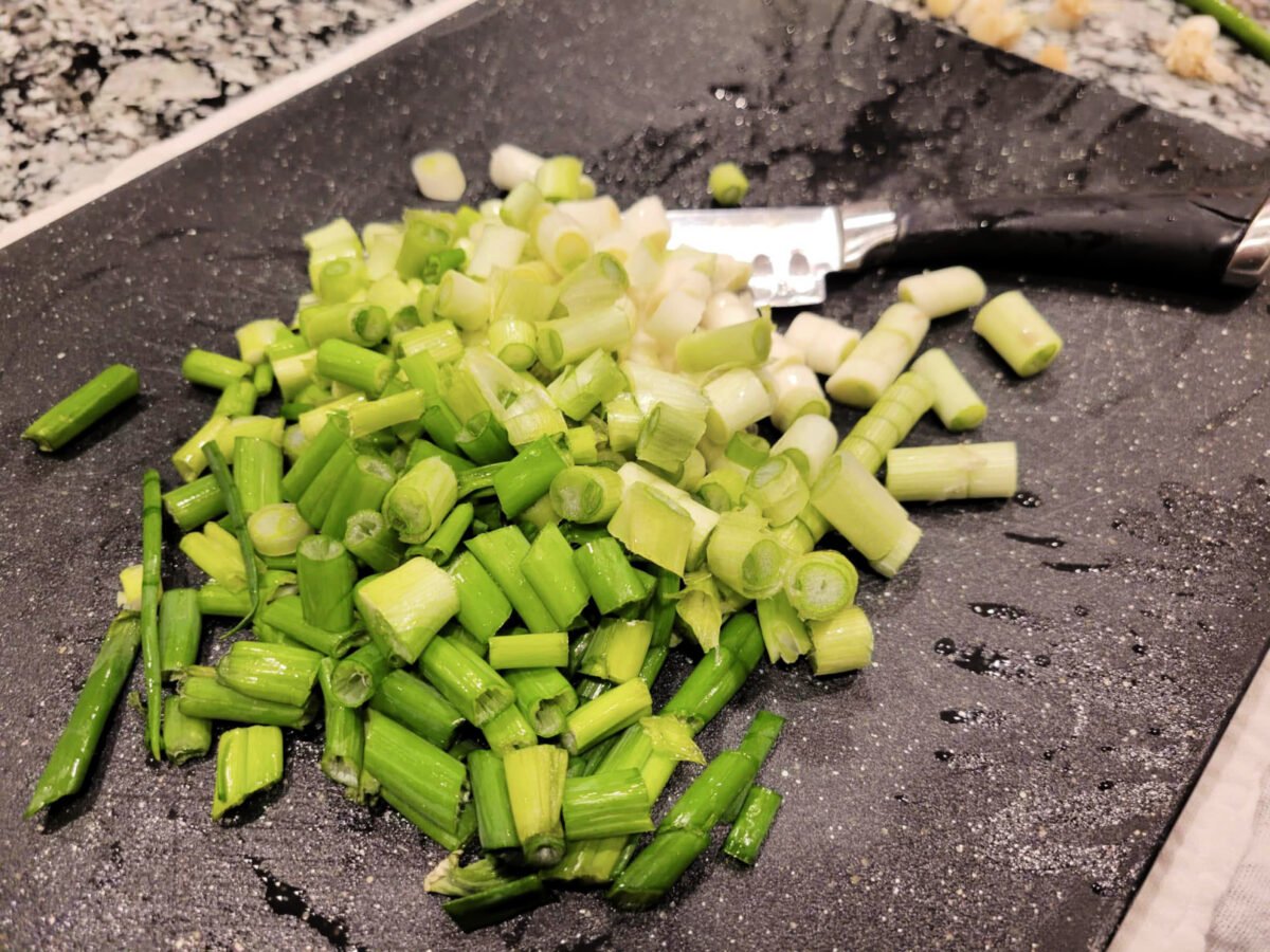 green onions chopped on a cutting board
