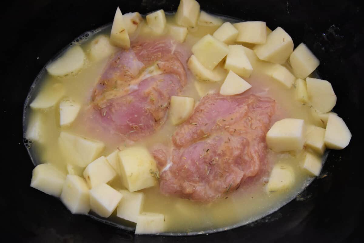 turkey and potatoes in a crockpot with chicken broth