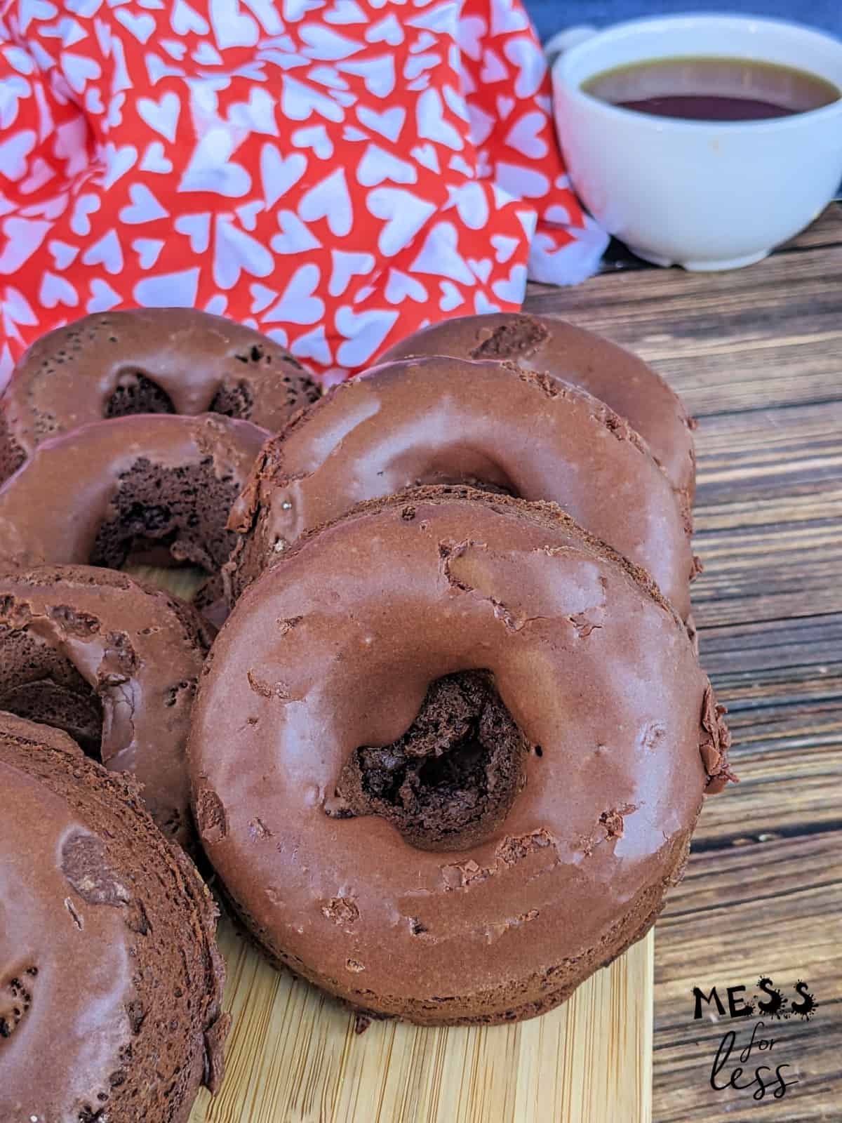 six chocolate donuts on cutting board