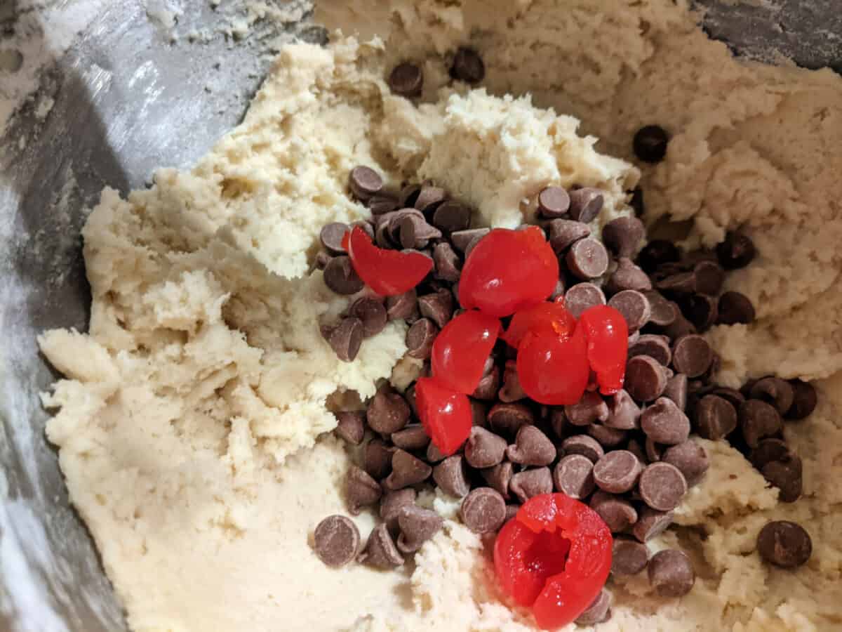 cookie dough chocolate chips and cherries in a bowl