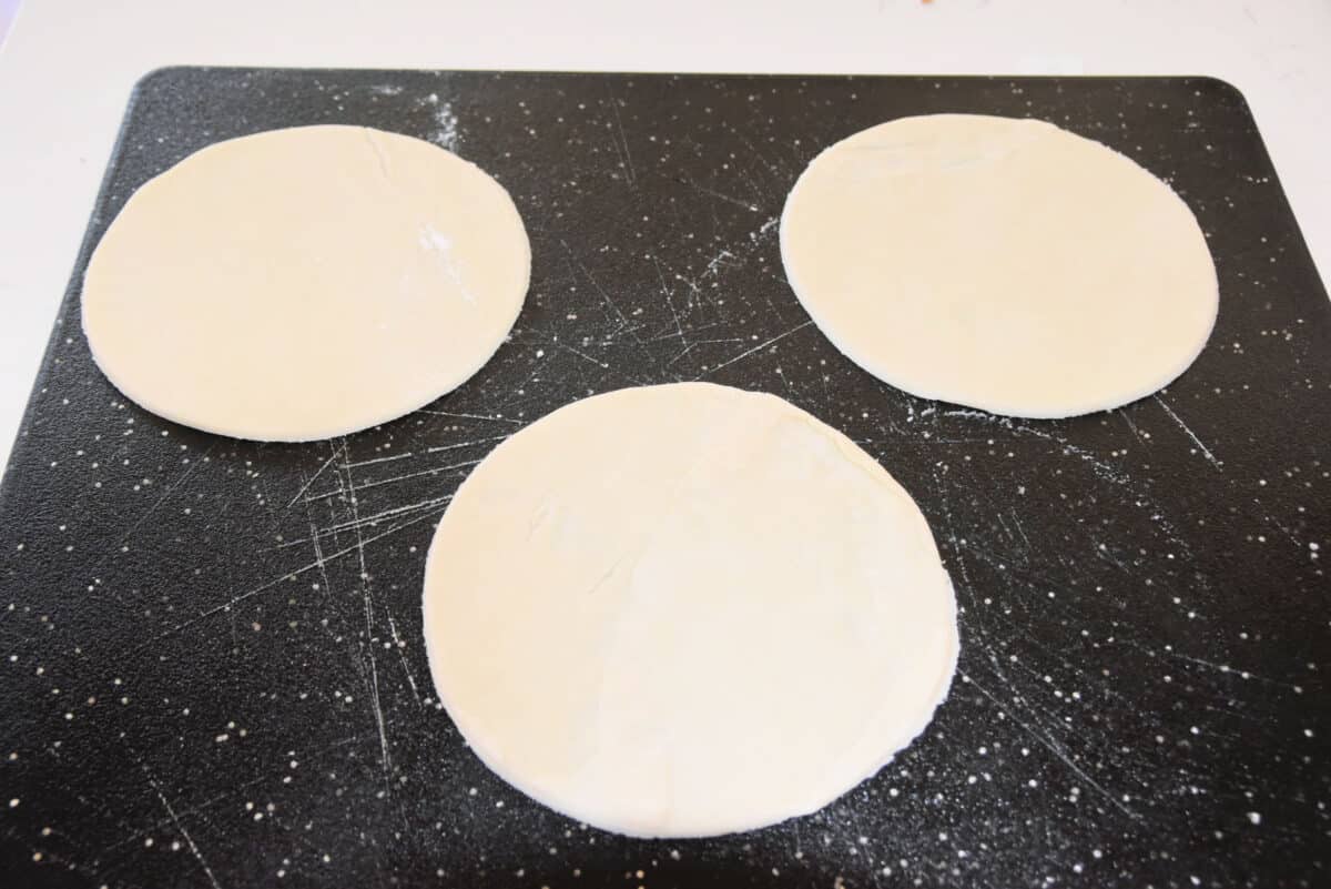 three rounds of dough on a cutting board