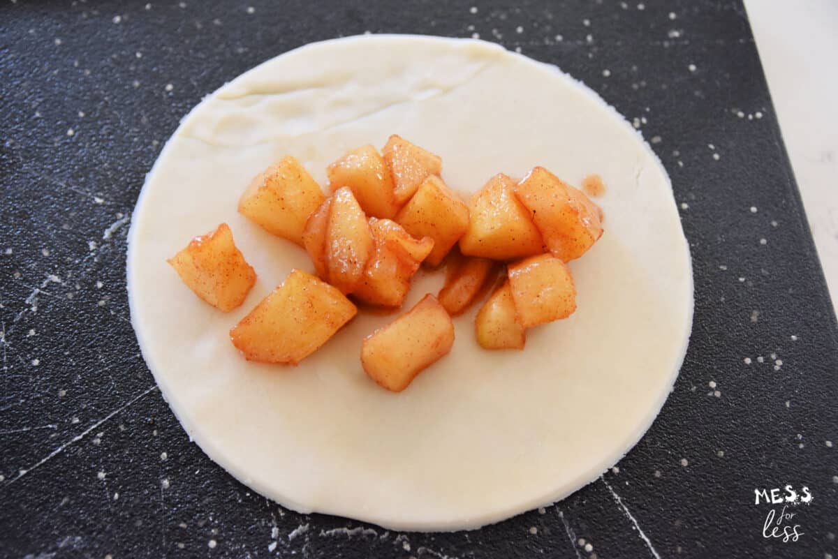 circle of dough with chopped apples in center