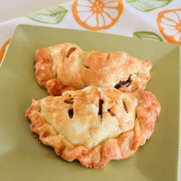 two apple turnovers on a green plate