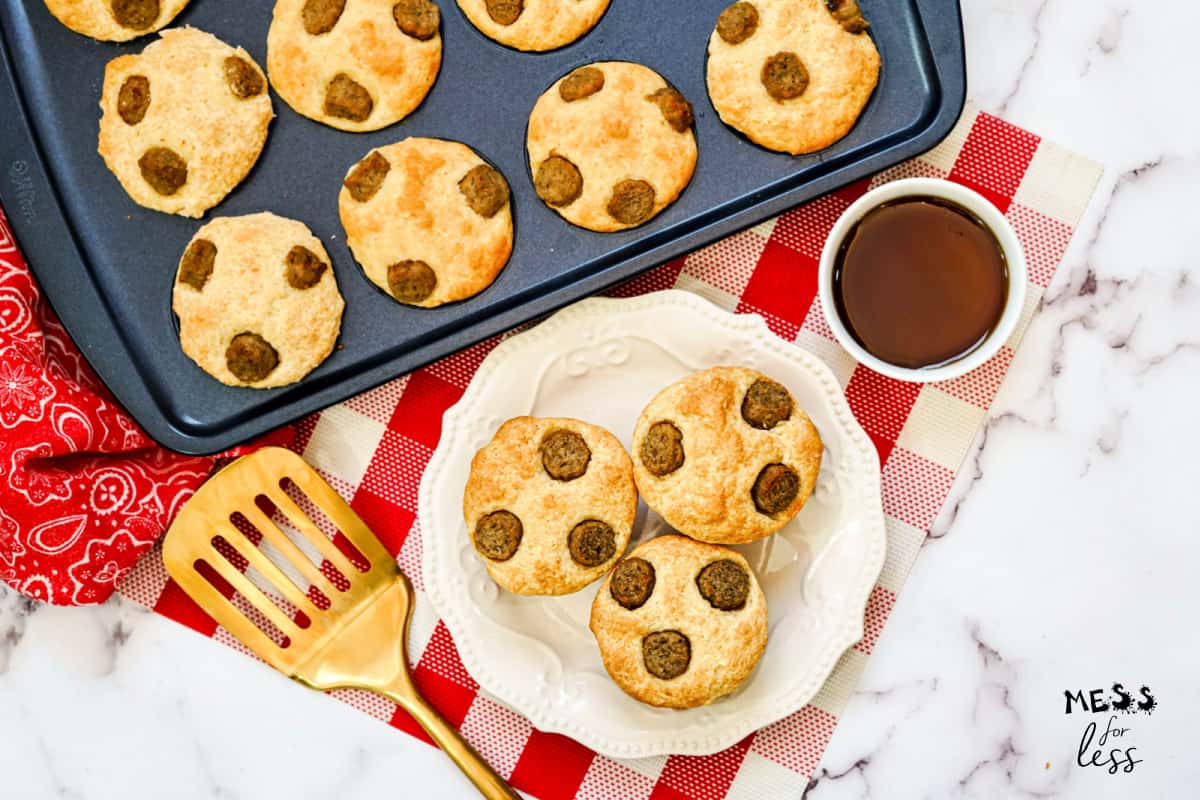 pancake muffins on a white plate with maple syrup on the side