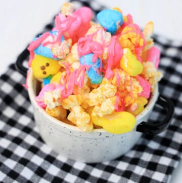 easter popcorn in a bowl on a black and white placemat