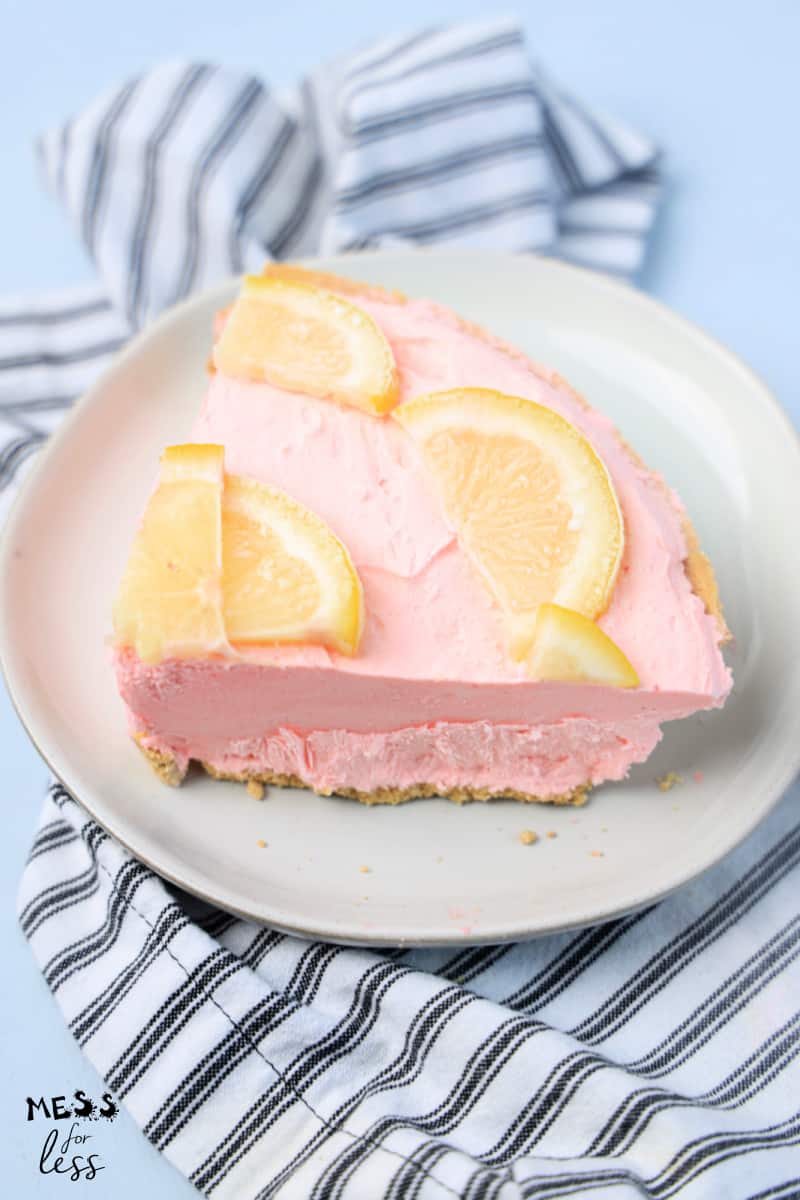 slice of pink lemonade pie with lemons