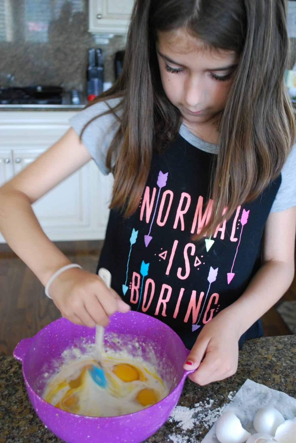 child making eggs and baking mix