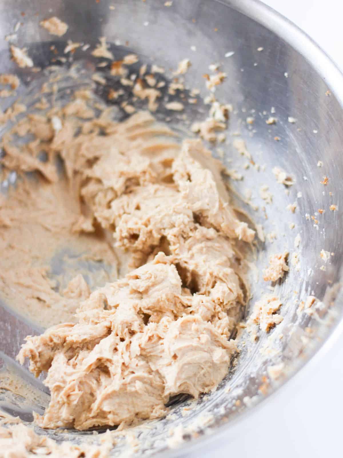 creaming brown sugar and cream cheese in a bowl