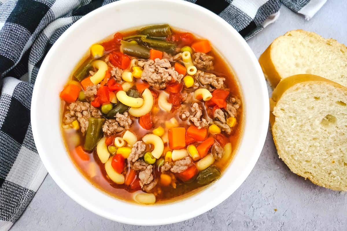 hamburger macaroni soup in a white bowl.