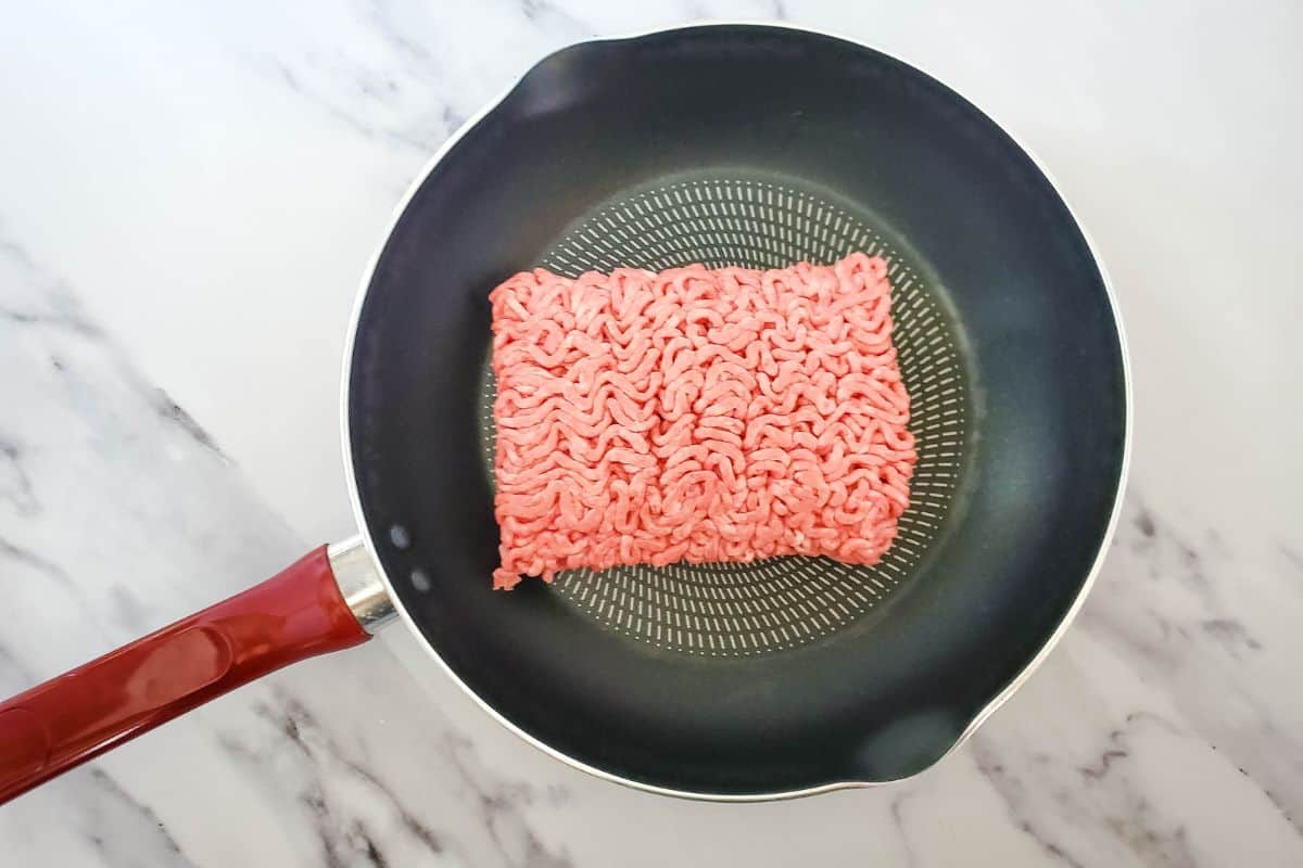 ground beef cooking in a pan.