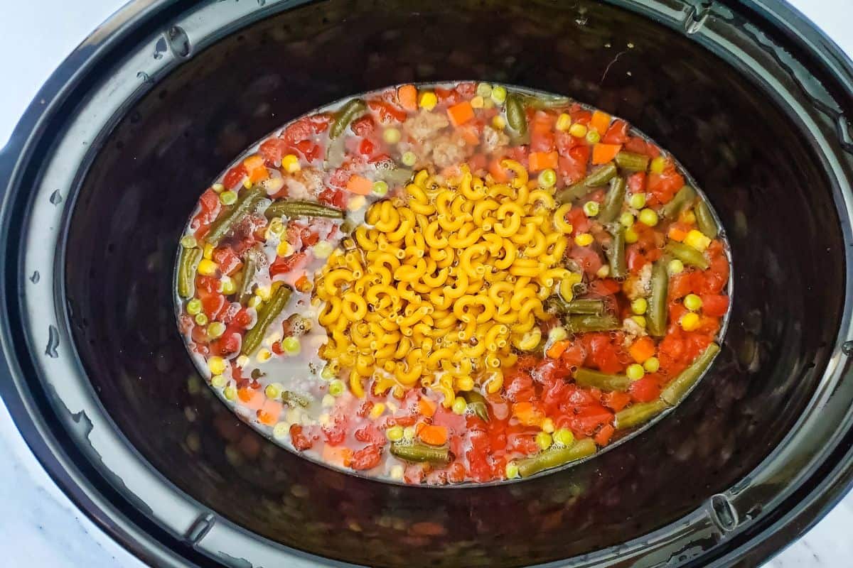 macaroni soup ingredients in a slow cooker.