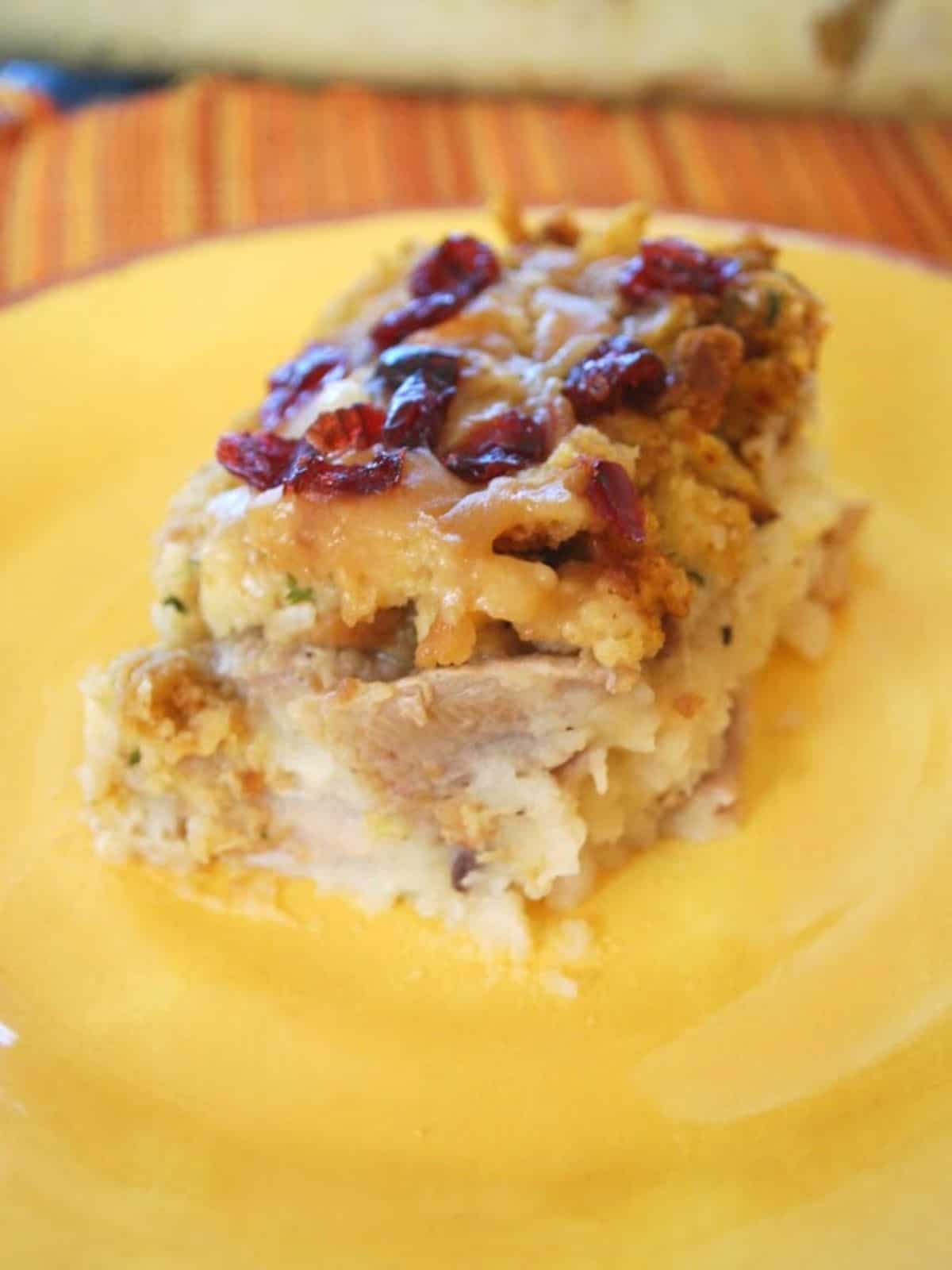 thanksgiving leftovers casserole on yellow plate.
