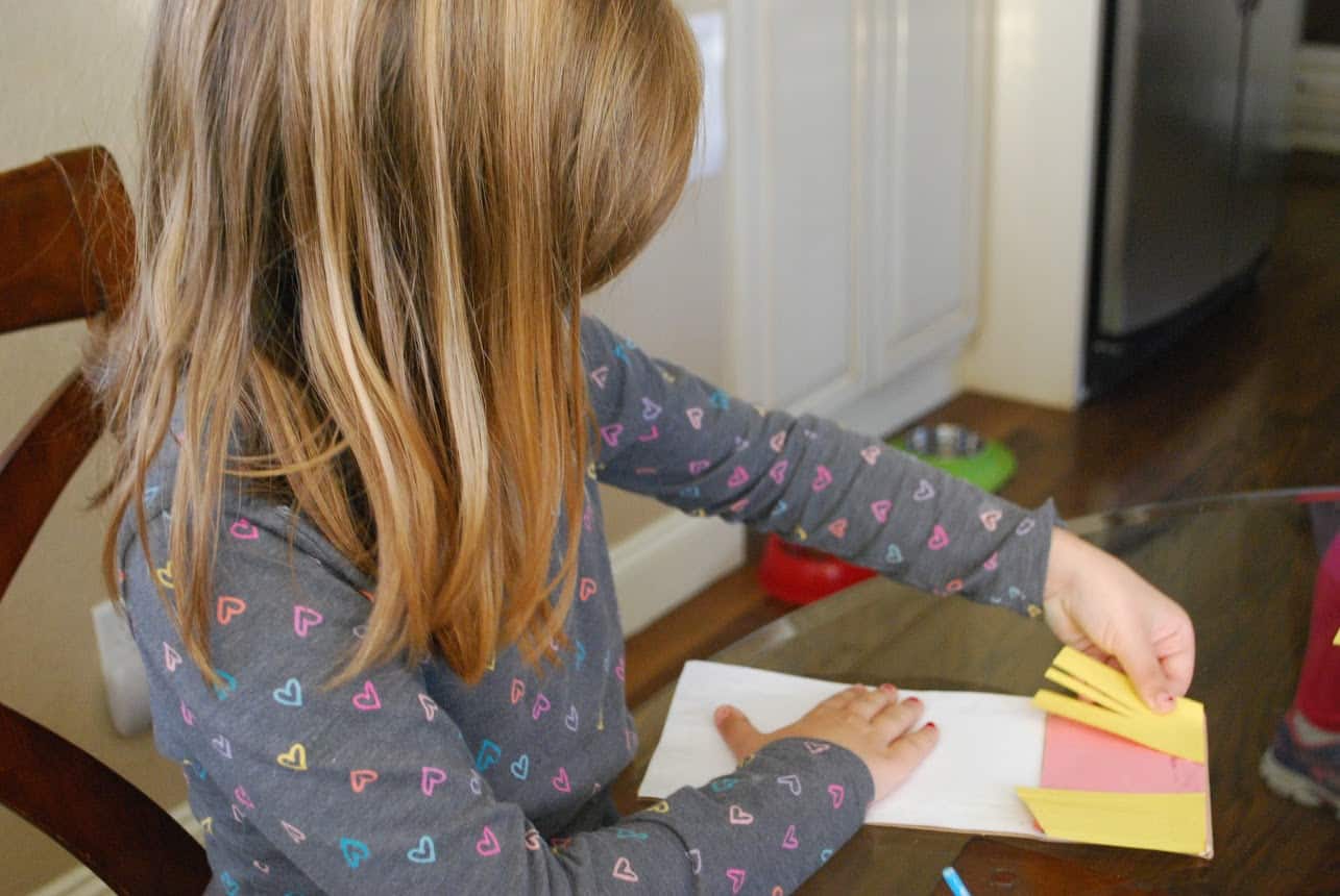 child making a paper bag craft.