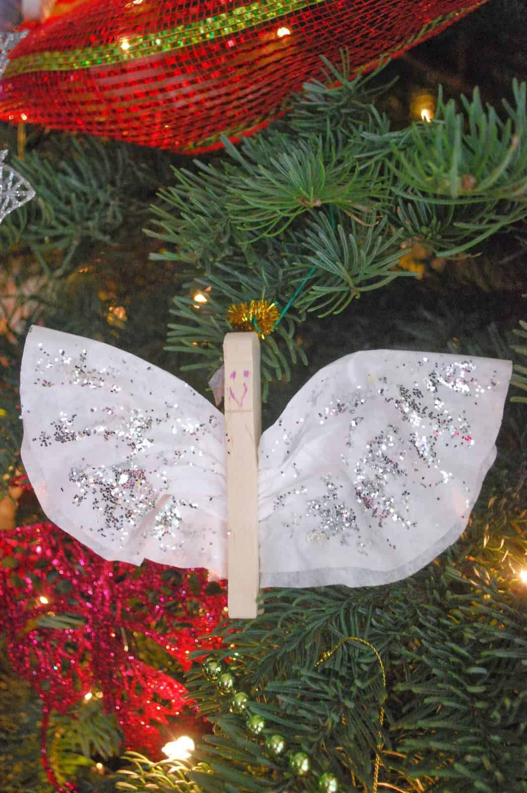 coffee filter and angel ornament hanging in a tree.