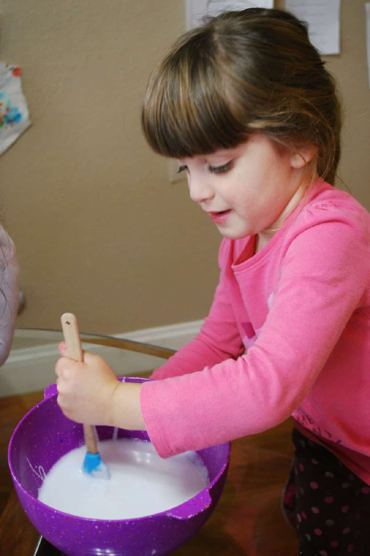 child mixing gak in a bowl