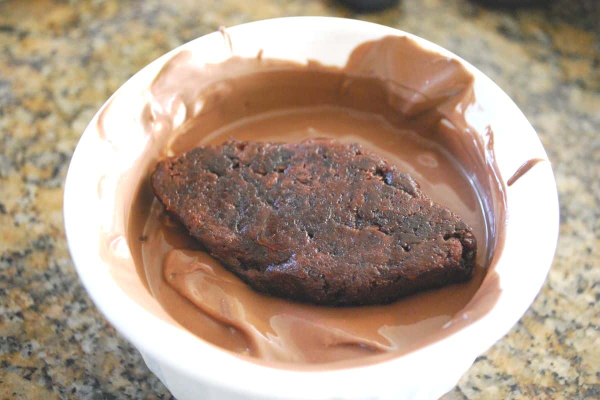 football brownie being dipped in chocolate