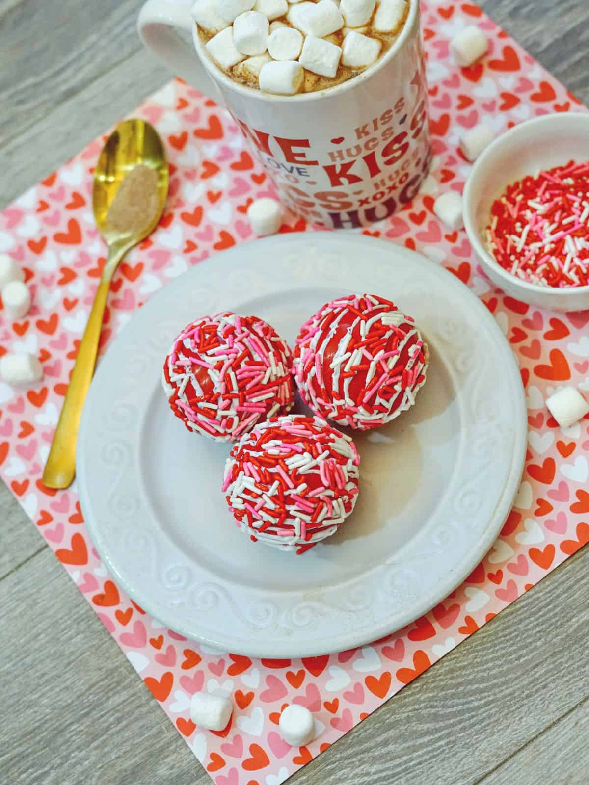 pink and red hot cocoa bombs on plate