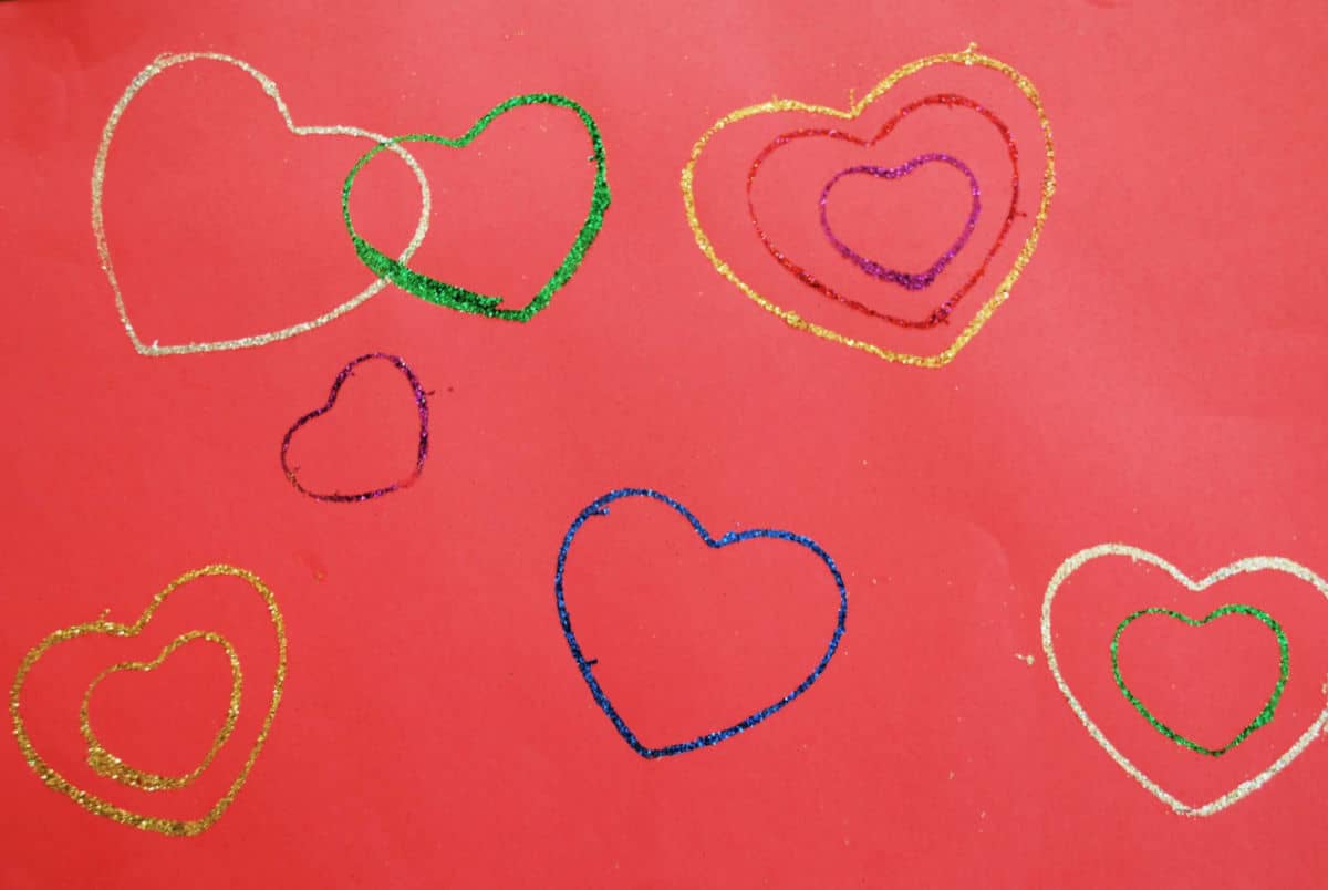 glitter hearts on red construction paper