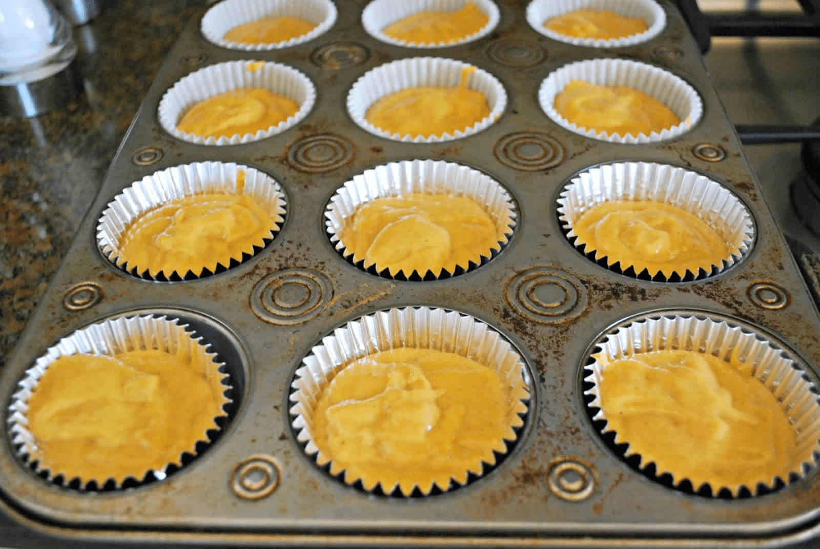 carrot muffin batter in muffin cups