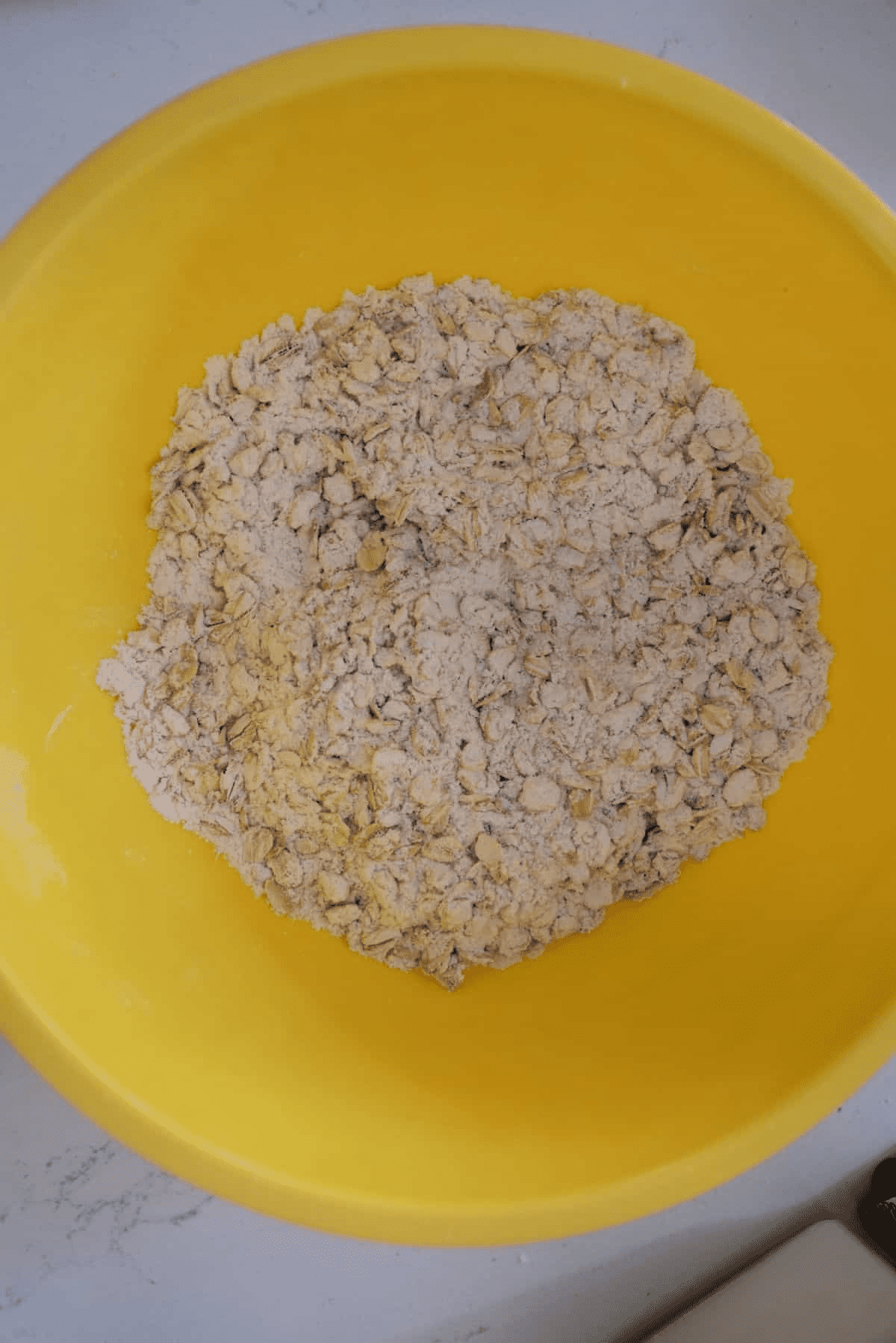 yellow bowl with rolled oats and flour