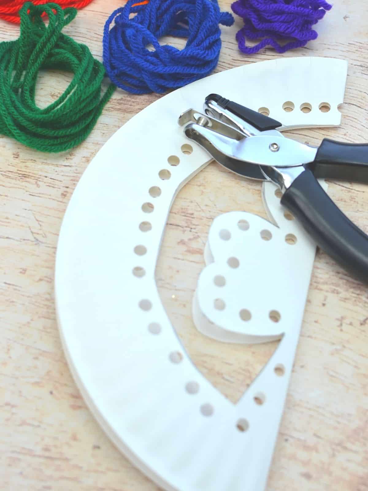 paper plate shamrock with holes punched in it