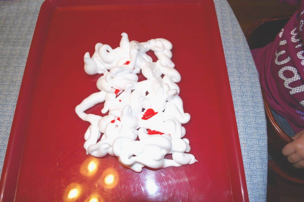 shaving cream on tray with red food coloring