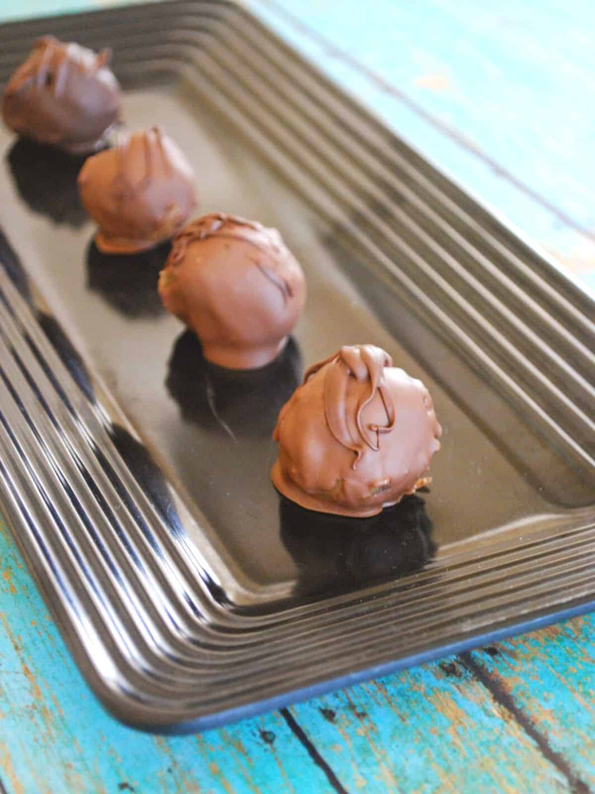 chocolate chip cookie dough truffles on a black plate