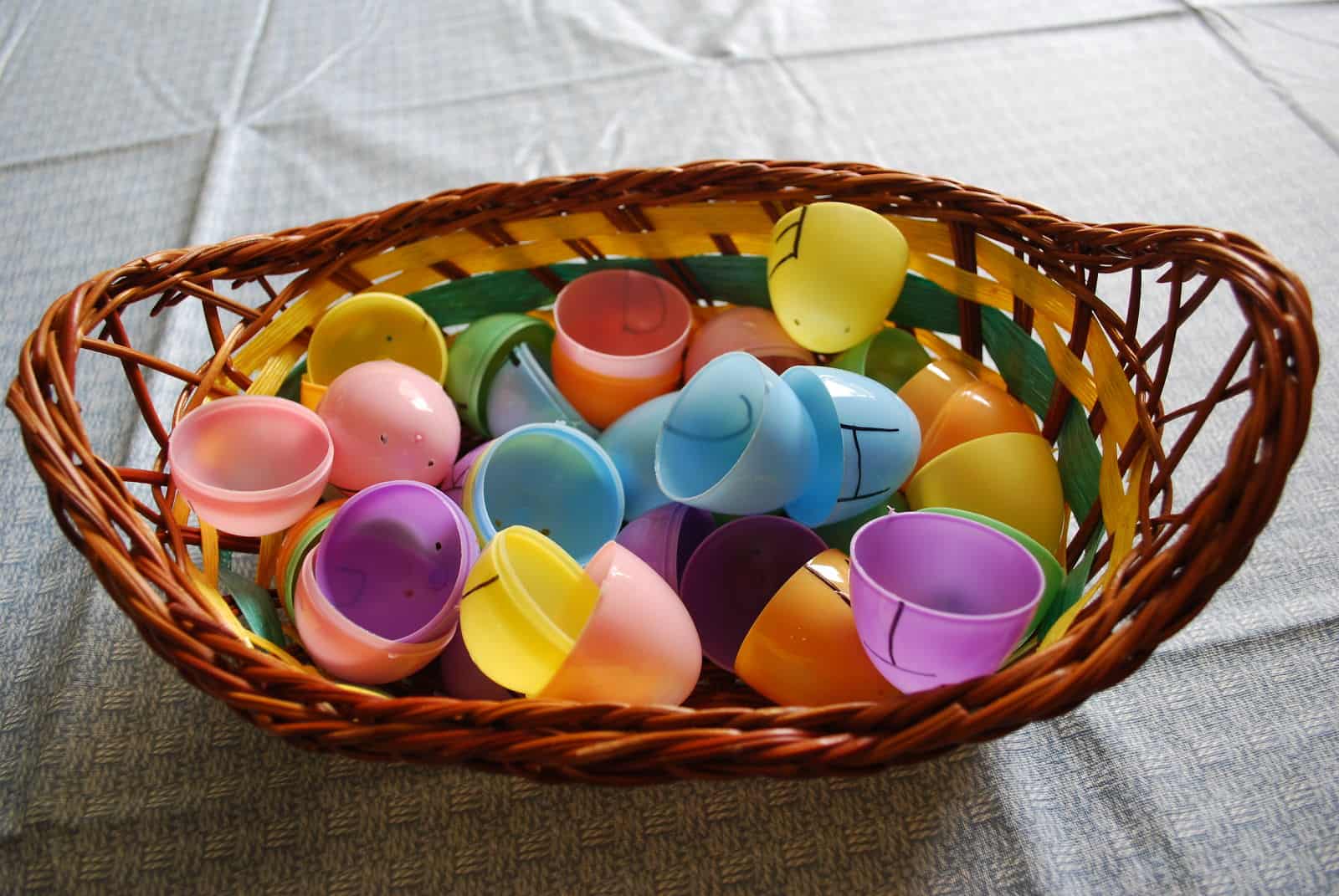 halves of plastic eggs in a basket.