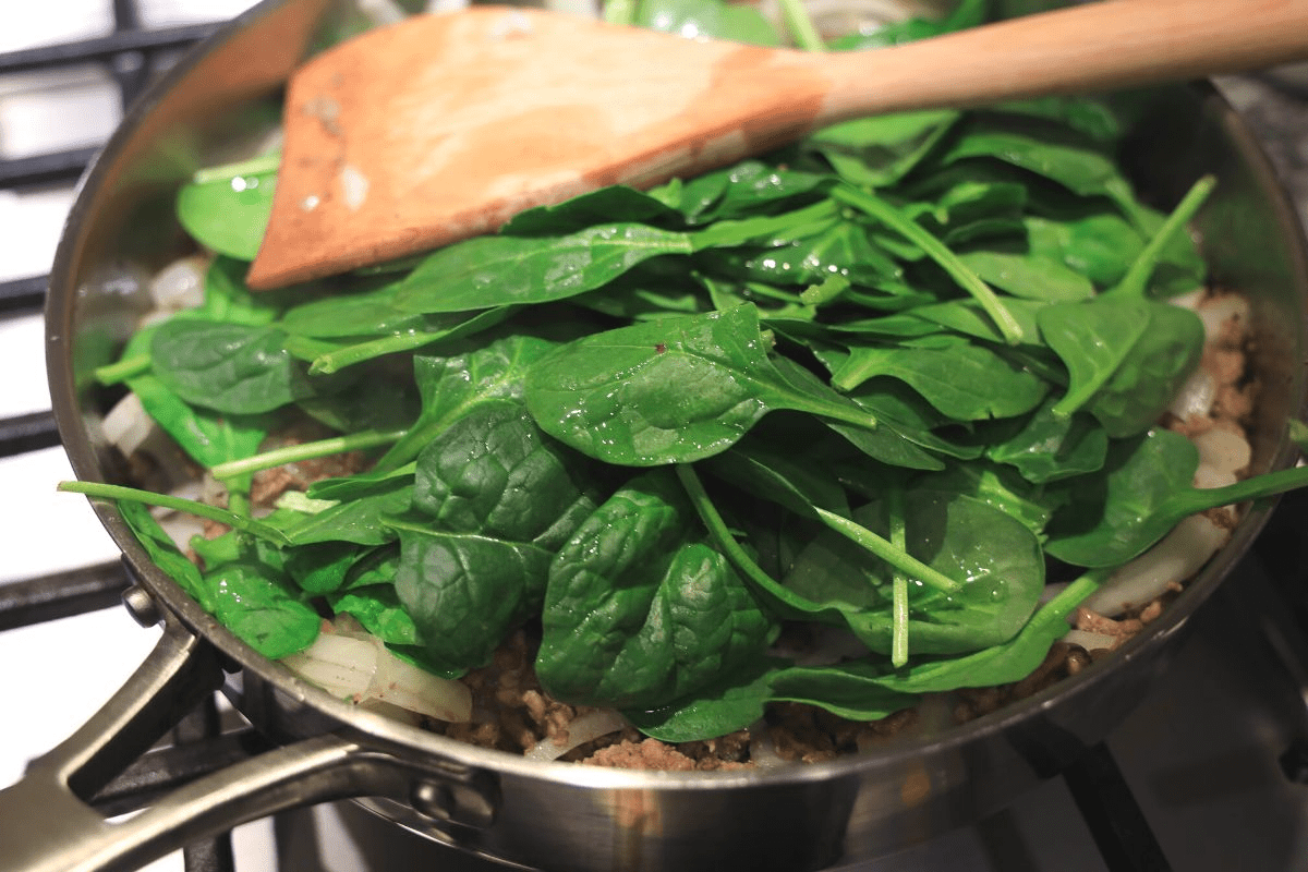 cooking spinach in pan