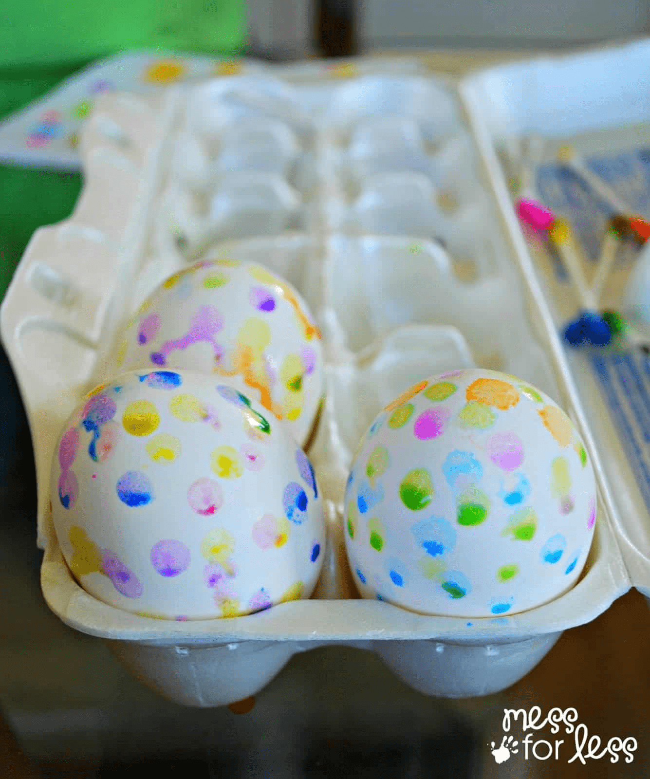 spotted decorated easter eggs in a foam egg carton