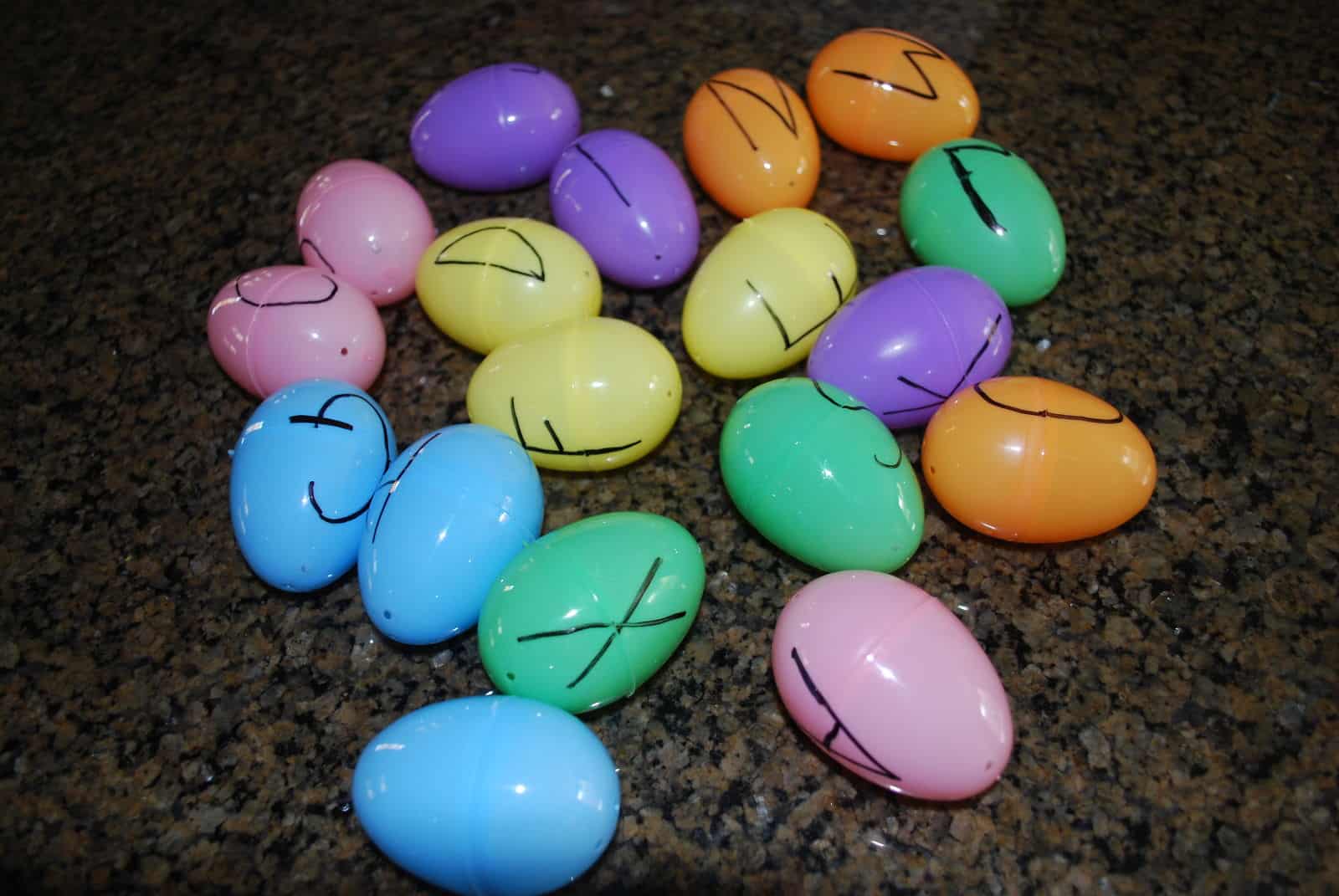 plastic easter eggs with letters written on them.