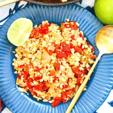 mexican cauliflower rice on playe with lime