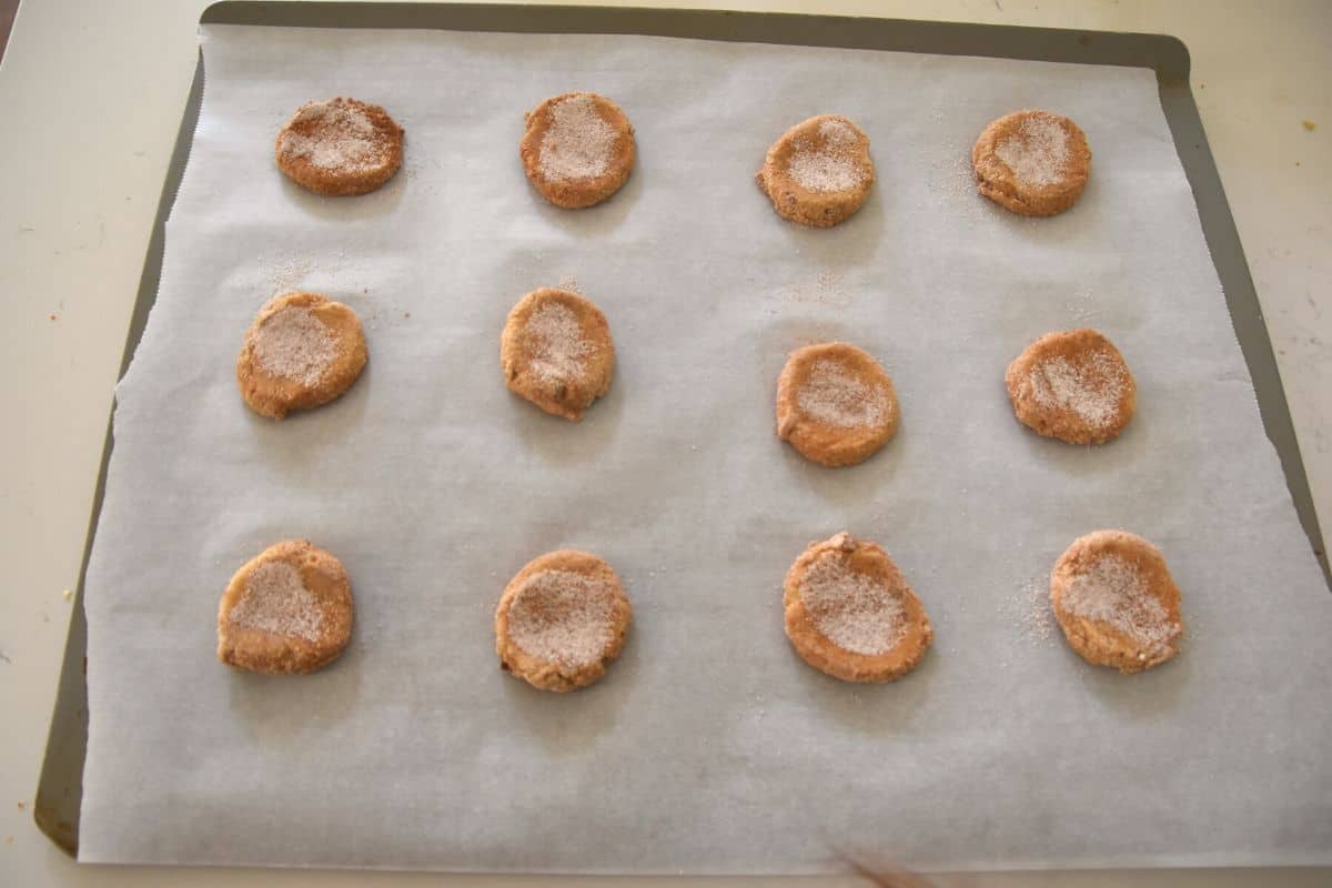 raw snickerdoodle cookies on cookie sheet