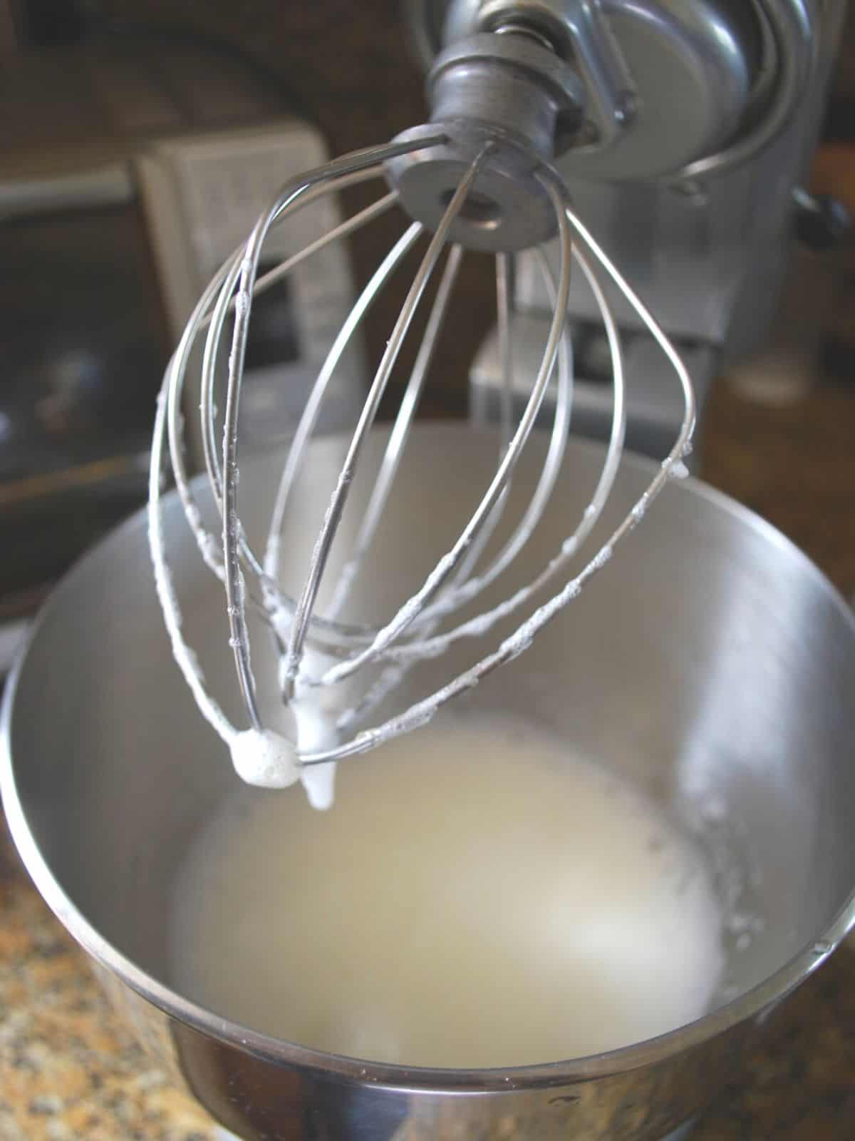 whipping egg whites in a stand mixer.