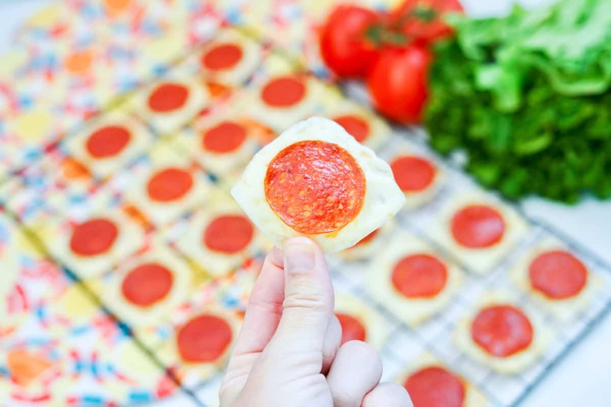 hand holding mozzarella pepperoni crisp