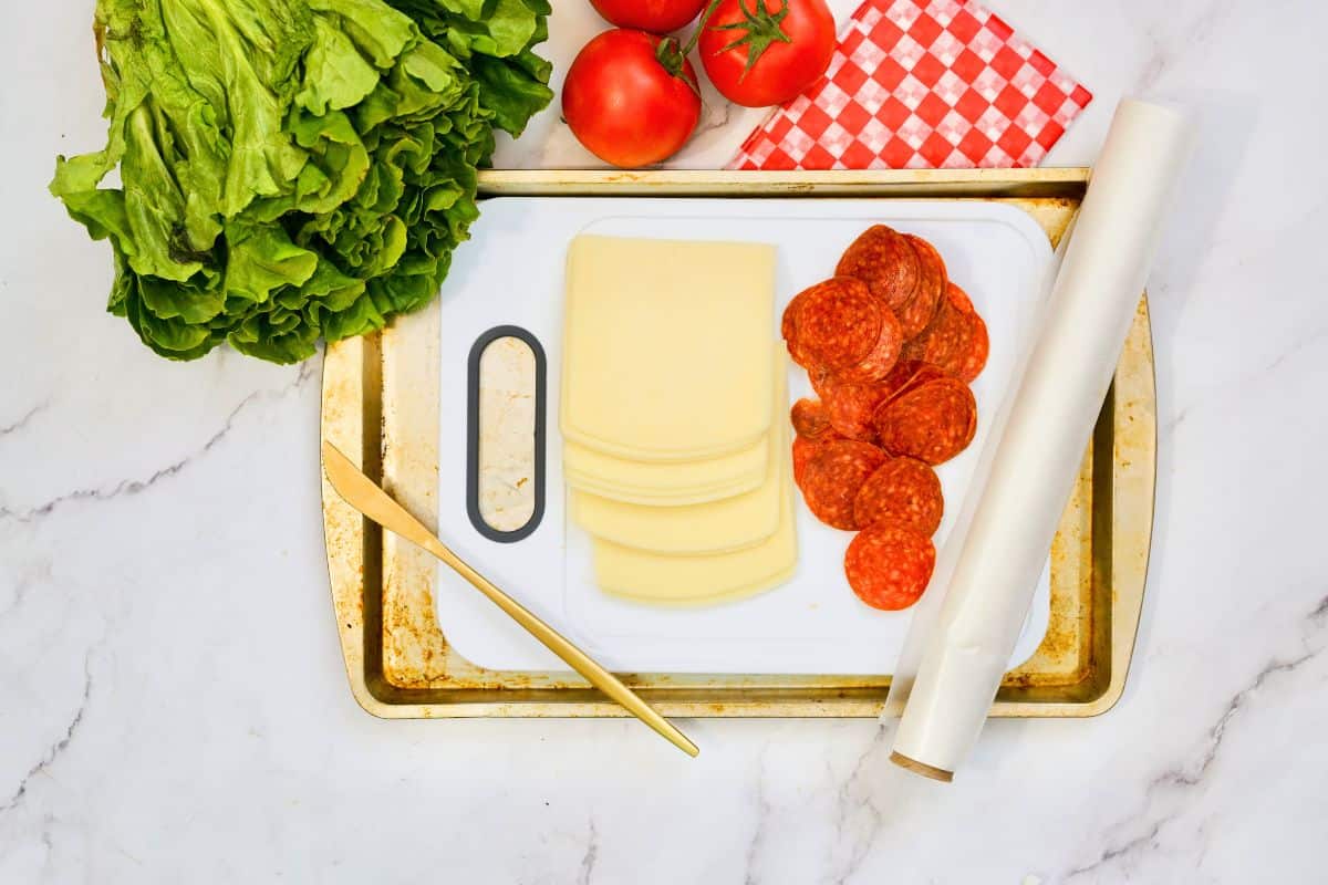 mozzarella and pepperoni on baking sheet